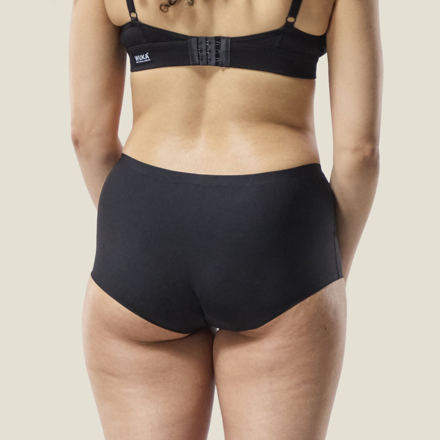 Rear view of WUKA Teen Stretch™ Boxer in black, highlighting full coverage and seamless comfort for heavy periods.