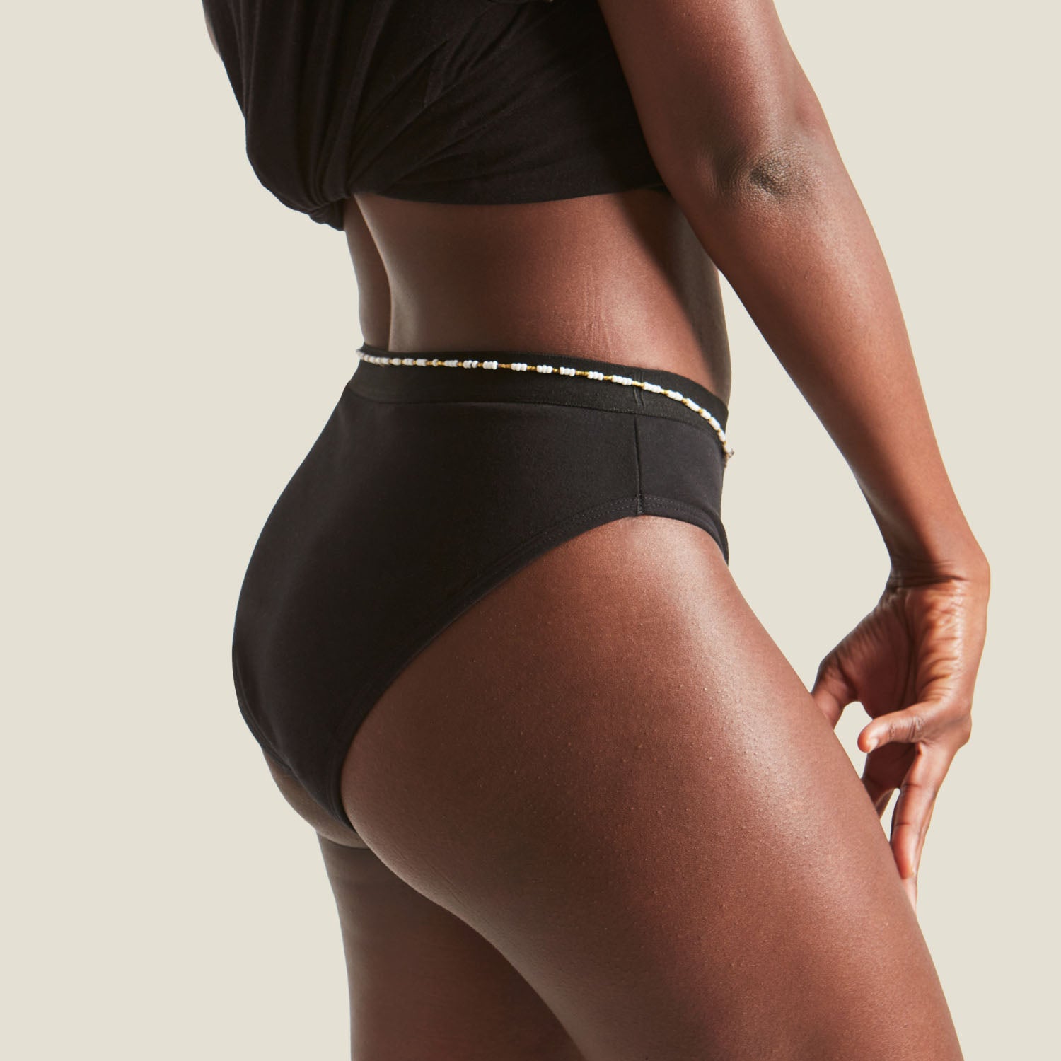 Side view of the WUKA Ultimate™ Bikini Medium Flow Period Pants, showing sleek fit and soft waistband on a model.